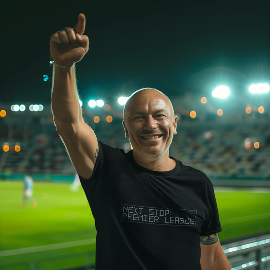 Man in a football stadium giving a thumbs-up with 'Next Stop: Premier League' print on a Black T-Shirt