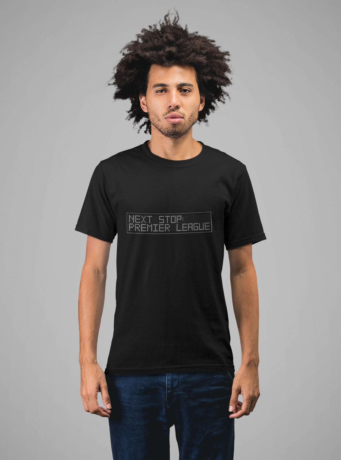 Person wearing a black t-shirt with 'Next Stop Premier League' text on a male model on a grey background