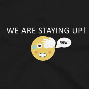 Close up of the product showing the text of we are staying up with a emoji with the phew sign on a black background