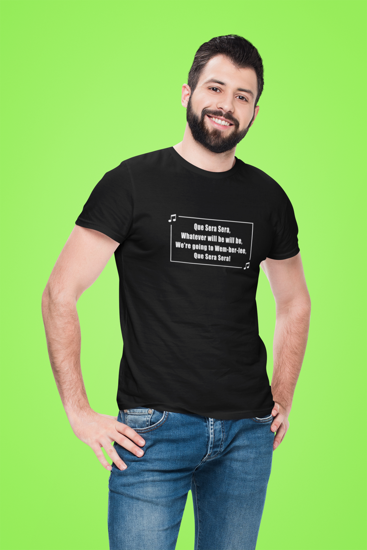 Man wearing a short sleeve black t-shirt with text saying Que Sera Sera We're going to Wem-ber-lee (Wembley)  on a green background