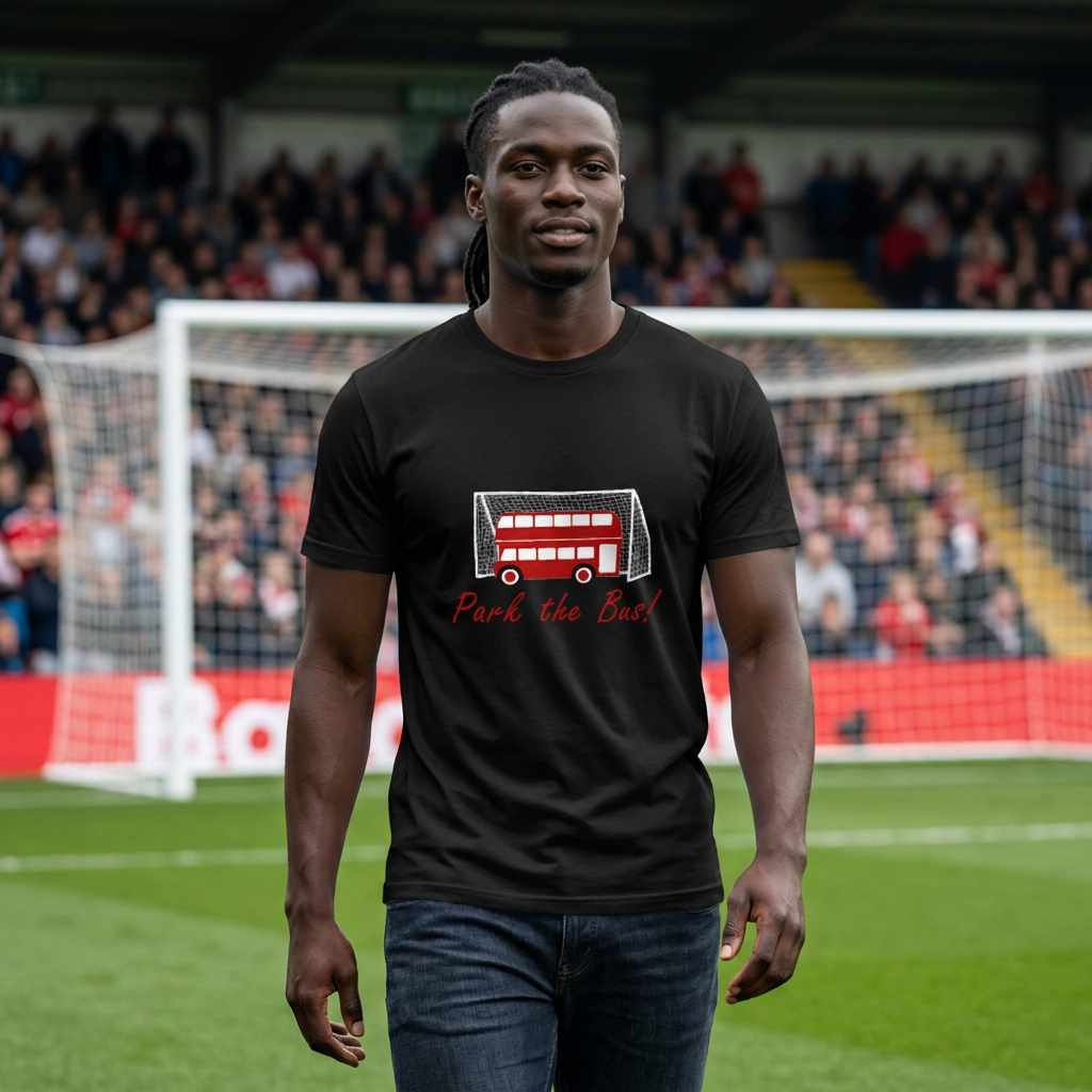Man walking on a football pitch in front of a goal wearing the black Park the Bus t-shirt