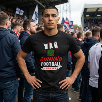 Fan in a football crowd wearing the black VAR Ruining Football Since 2018 t-shirt in red and white