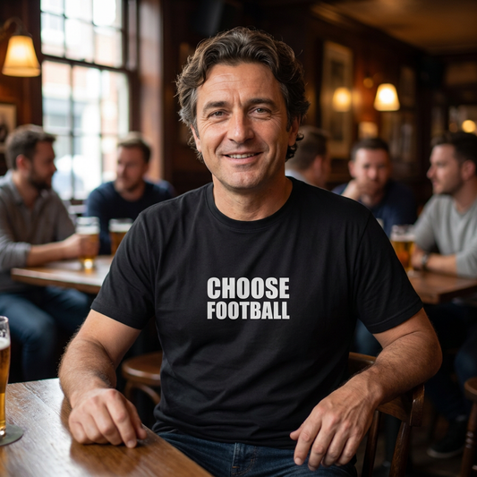 Man in a pub wearing the black Choose Football slogan t-shirt with bold white lettering